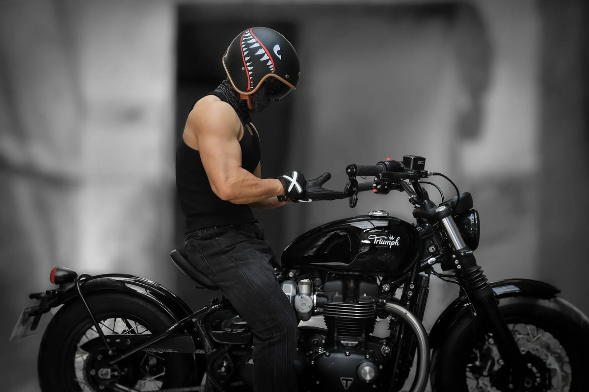 Rider in a full-face helmet sitting on a black cruiser