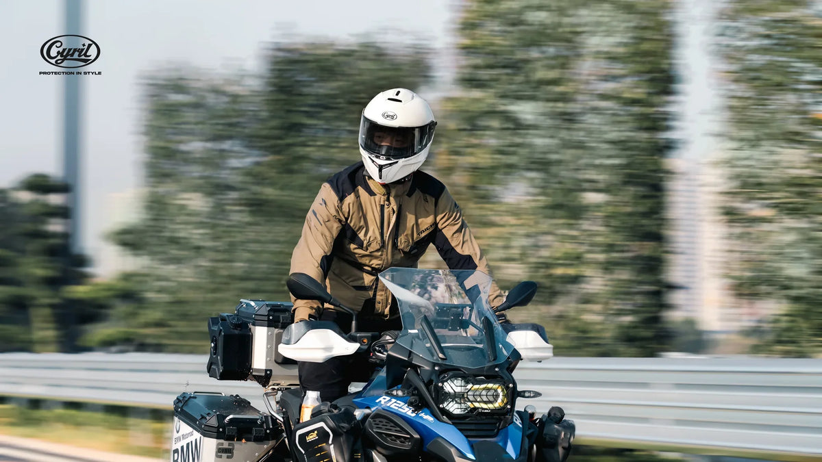Rider in a white full-face helmet on an adventure bike
